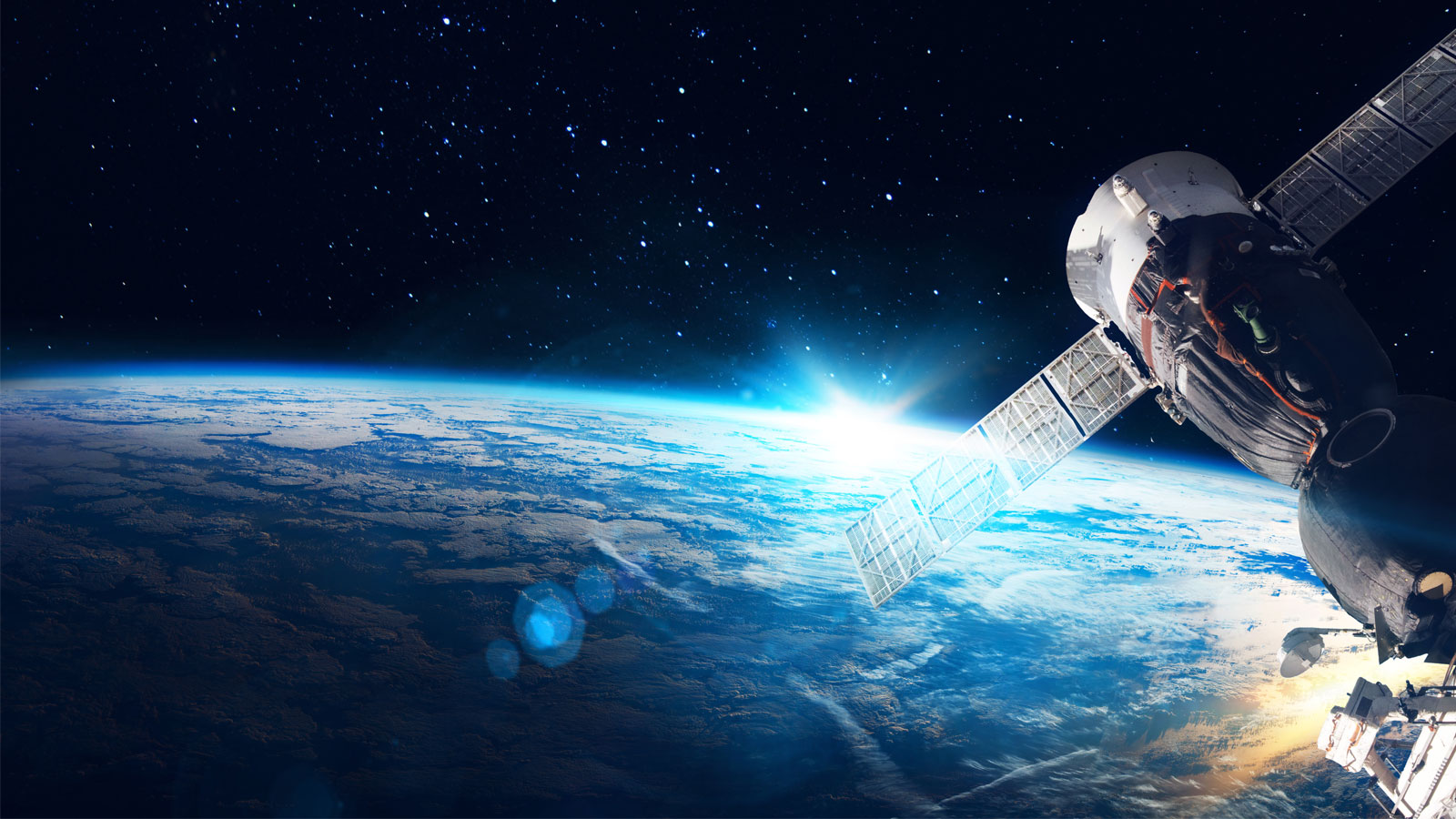 A satellite with extended solar panels floats in space above the Earth.