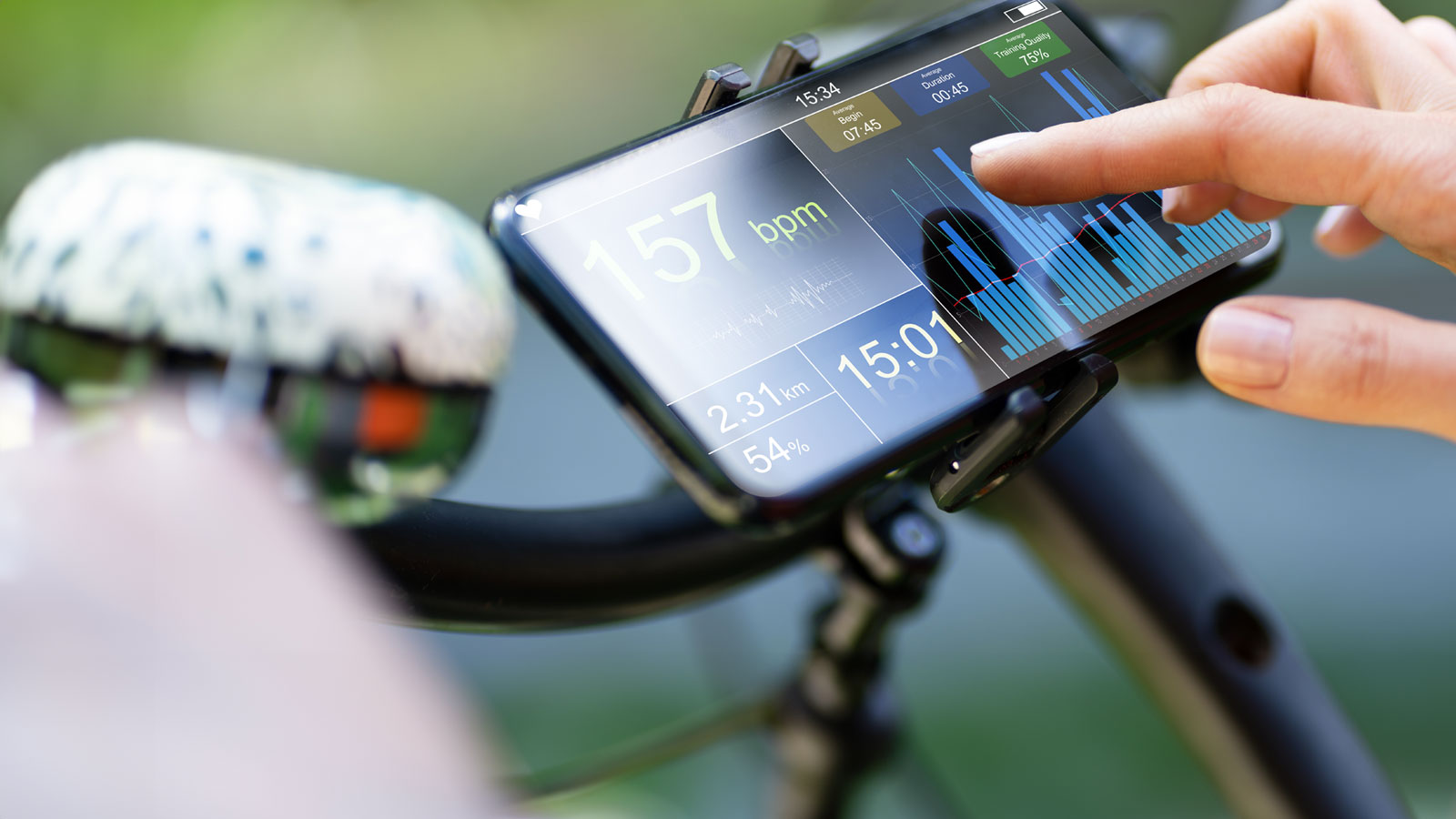 Close-up of a smartphone secured in a handlebar mount, display showing a fitness dashboard with large "157 bpm" heart rate, smaller readouts including "2.31 km", "15:01" and "54%", and a blue bar chart.