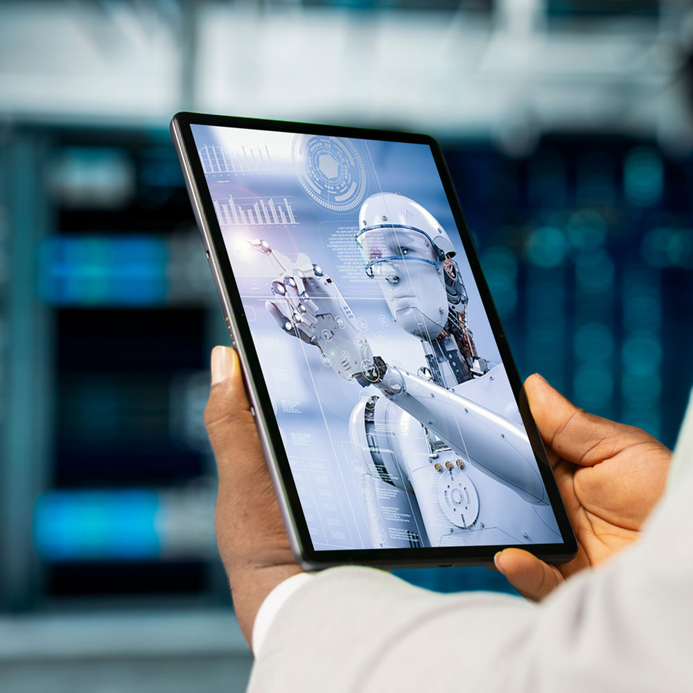 Man holding a tablet displaying a robot with a digital interface.